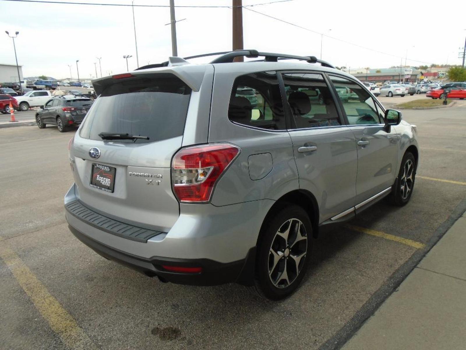 2016 Ice Silver Metallic /Black Subaru Forester 2.0XT Touring (JF2SJGXC1GH) with an 2.0 liter 4 Cylinder Engine engine, Lineartronic CVT transmission, located at 222 N Cambell St., Rapid City, SD, 57701, (866) 420-2727, 44.081833, -103.191032 - This vehicle is a certified CARFAX 1-owner. Our dealership has already run the CARFAX report and it is clean. A clean CARFAX is a great asset for resale value in the future. It is equipped with all wheel drive. This Subaru Forester gleams with an elegant silver clear coated finish. Expand the cargo - Photo #4