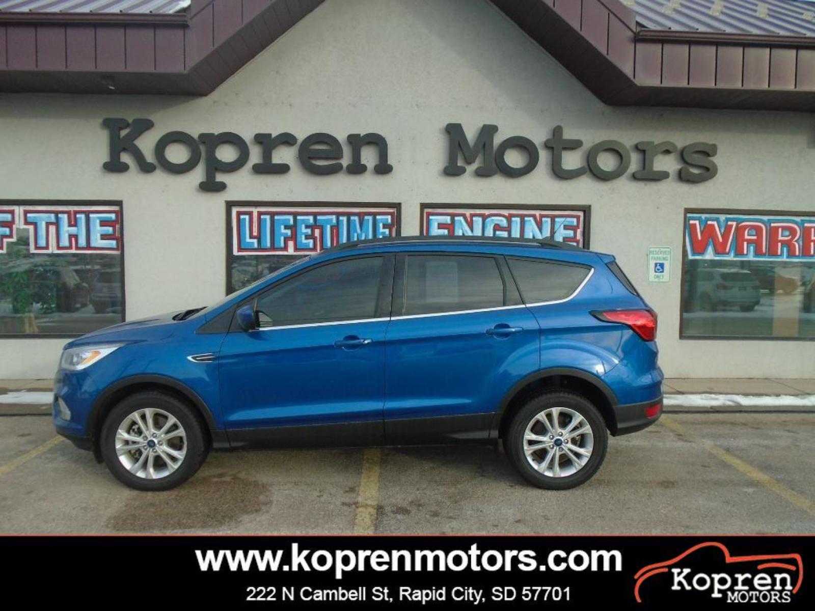 2019 Lightning Blue Metallic Ford Escape SEL (1FMCU9HD4KU) with an 1.5 liter 4 Cylinder Engine engine, 6-SPEED AUTOMATIC W/SELECTSHIFT transmission, located at 222 N Cambell St., Rapid City, SD, 57701, (866) 420-2727, 44.081833, -103.191032 - It has a clean CARFAX vehicle history report. The state of the art park assist system will guide you easily into any spot. Protect this unit from unwanted accidents with a cutting edge backup camera system. Never get into a cold vehicle again with the remote start feature on this unit. This vehicle - Photo #0