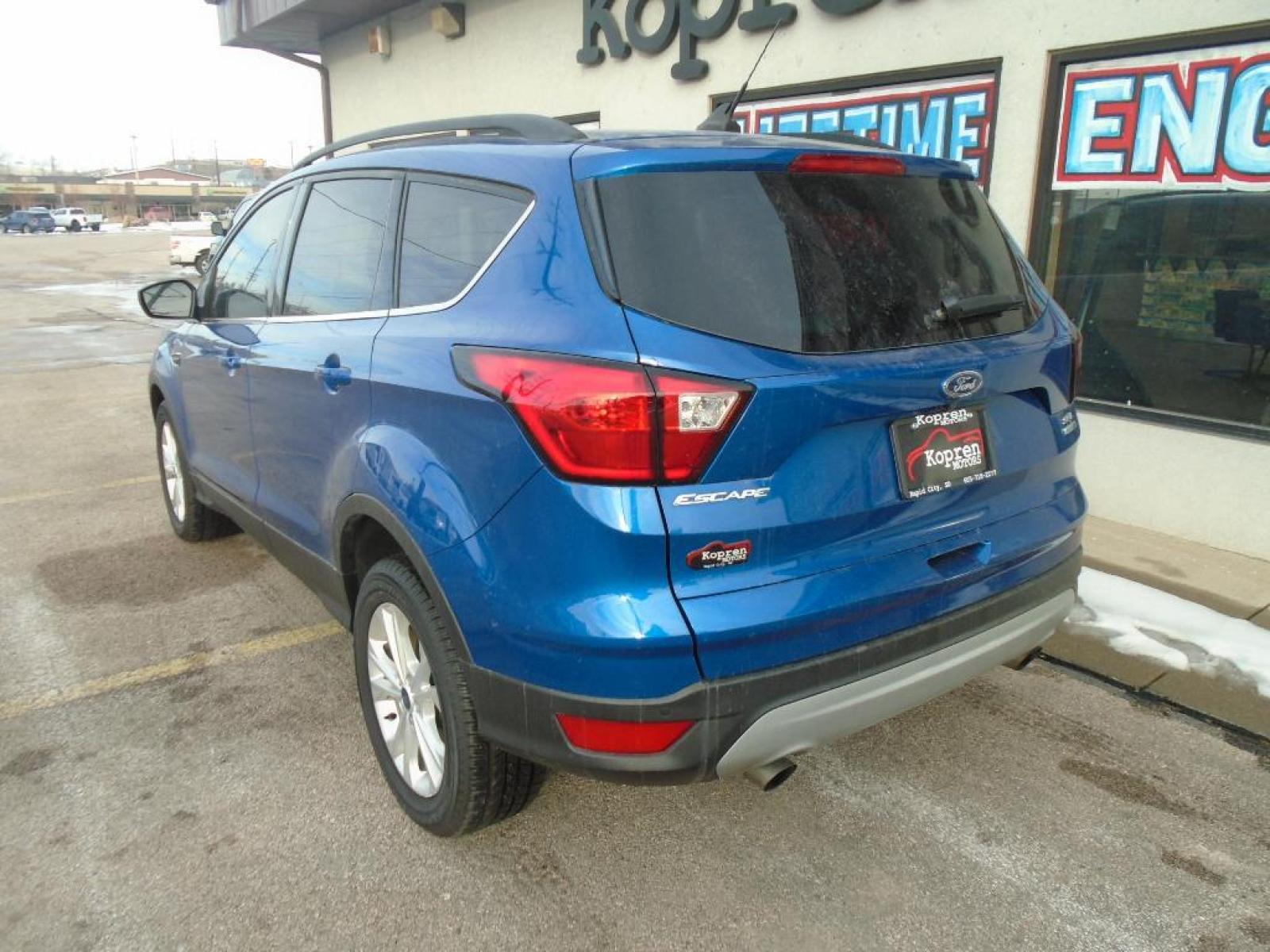 2019 Lightning Blue Metallic Ford Escape SEL (1FMCU9HD4KU) with an 1.5 liter 4 Cylinder Engine engine, 6-SPEED AUTOMATIC W/SELECTSHIFT transmission, located at 222 N Cambell St., Rapid City, SD, 57701, (866) 420-2727, 44.081833, -103.191032 - It has a clean CARFAX vehicle history report. The state of the art park assist system will guide you easily into any spot. Protect this unit from unwanted accidents with a cutting edge backup camera system. Never get into a cold vehicle again with the remote start feature on this unit. This vehicle - Photo #1