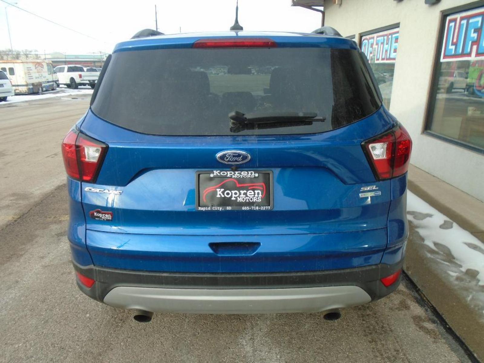 2019 Lightning Blue Metallic Ford Escape SEL (1FMCU9HD4KU) with an 1.5 liter 4 Cylinder Engine engine, 6-SPEED AUTOMATIC W/SELECTSHIFT transmission, located at 222 N Cambell St., Rapid City, SD, 57701, (866) 420-2727, 44.081833, -103.191032 - It has a clean CARFAX vehicle history report. The state of the art park assist system will guide you easily into any spot. Protect this unit from unwanted accidents with a cutting edge backup camera system. Never get into a cold vehicle again with the remote start feature on this unit. This vehicle - Photo #2