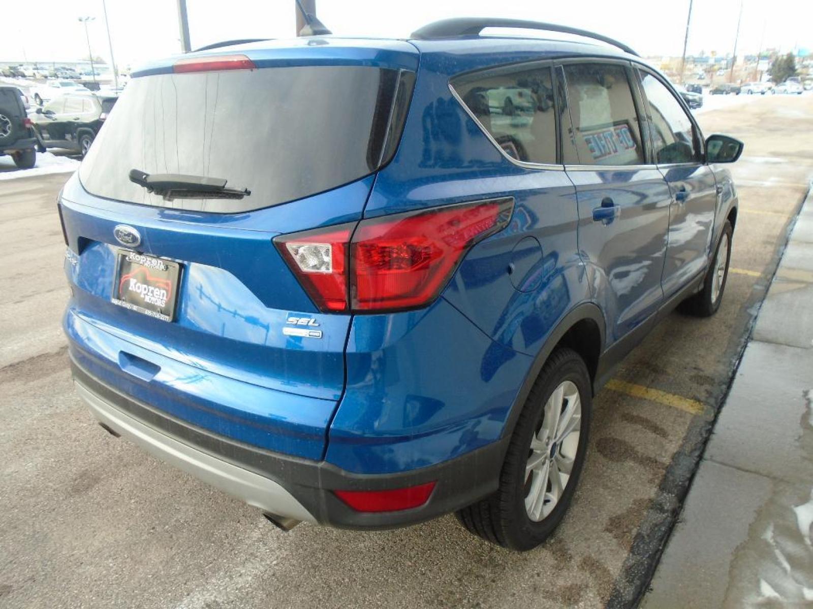 2019 Lightning Blue Metallic Ford Escape SEL (1FMCU9HD4KU) with an 1.5 liter 4 Cylinder Engine engine, 6-SPEED AUTOMATIC W/SELECTSHIFT transmission, located at 222 N Cambell St., Rapid City, SD, 57701, (866) 420-2727, 44.081833, -103.191032 - It has a clean CARFAX vehicle history report. The state of the art park assist system will guide you easily into any spot. Protect this unit from unwanted accidents with a cutting edge backup camera system. Never get into a cold vehicle again with the remote start feature on this unit. This vehicle - Photo #3