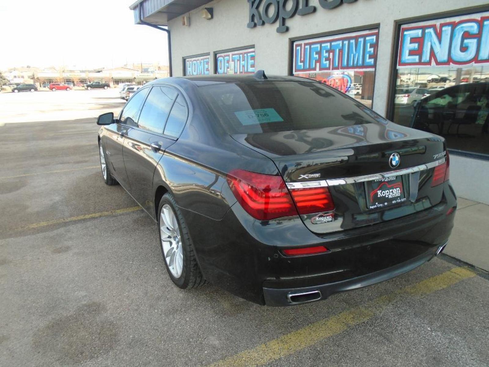 2015 BLACK BMW 7 series 750Li xDrive (WBAYF8C54FG) with an 4.4 liter 8 Cylinder Engine engine, Automatic transmission, located at 222 N Cambell St., Rapid City, SD, 57701, (866) 420-2727, 44.081833, -103.191032 - This vehicle is a certified CARFAX 1-owner. The rear parking assist technology on this 2015 BMW 7 series will put you at ease when reversing. The system alerts you as you get closer to an obstruction. See what's behind you with the back up camera on the BMW 7 series. This model has a 4.4 liter 8 C - Photo #1