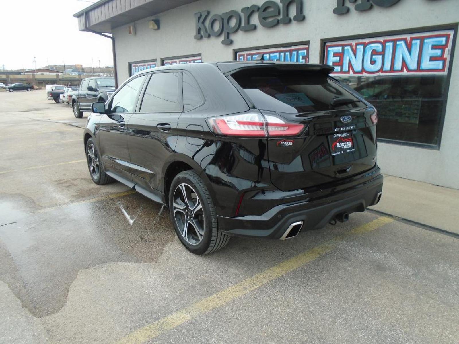 2022 Agate Black Metallic /Ebony Ford Edge ST (2FMPK4AP7NB) with an 2.7 liter V6 Cylinder Engine engine, 7-SPEED AUTOMATIC W/SELECTSHIFT transmission, located at 222 N Cambell St., Rapid City, SD, 57701, (866) 420-2727, 44.081833, -103.191032 - This vehicle is a certified CARFAX 1-owner. The rear parking assist technology on the vehicle will put you at ease when reversing. The system alerts you as you get closer to an obstruction. See what's behind you with the back up camera on this model. It has a clean CARFAX vehicle history report. Th - Photo #1