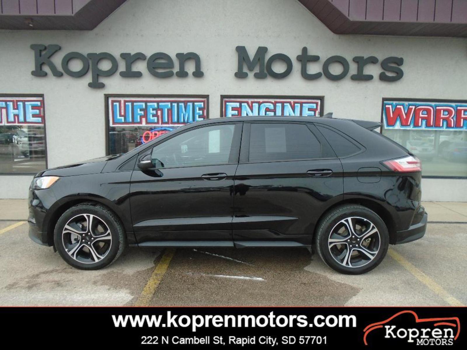 2022 Agate Black Metallic /Ebony Ford Edge ST (2FMPK4AP7NB) with an 2.7 liter V6 Cylinder Engine engine, 7-SPEED AUTOMATIC W/SELECTSHIFT transmission, located at 222 N Cambell St., Rapid City, SD, 57701, (866) 420-2727, 44.081833, -103.191032 - This vehicle is a certified CARFAX 1-owner. The rear parking assist technology on the vehicle will put you at ease when reversing. The system alerts you as you get closer to an obstruction. See what's behind you with the back up camera on this model. It has a clean CARFAX vehicle history report. Th - Photo #0