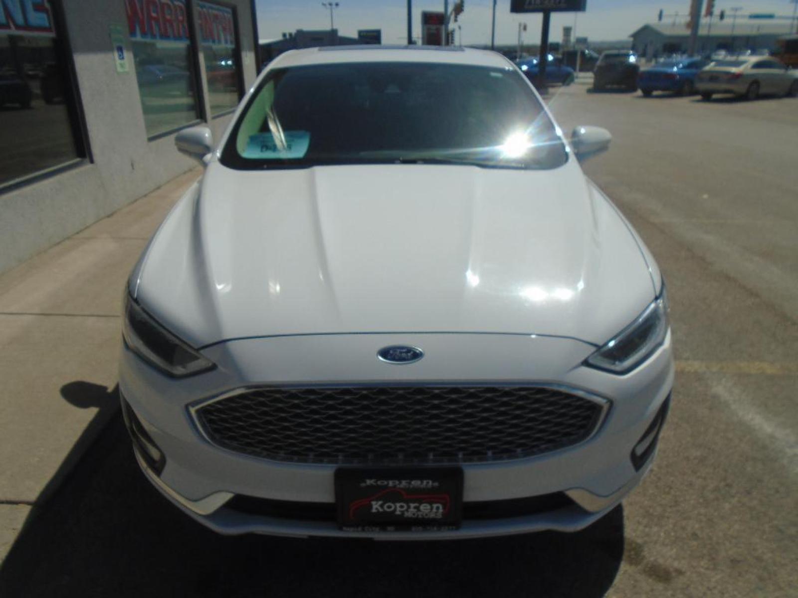 2019 Oxford White /Russet Ford Fusion Titanium (3FA6P0D98KR) with an L4, 2.0L engine, 6-speed automatic transmission, located at 222 N Cambell St., Rapid City, SD, 57701, (866) 420-2727, 44.081833, -103.191032 - <b>Equipment</b><br>The rear parking assist technology on this Ford Fusion will put you at ease when reversing. The system alerts you as you get closer to an obstruction. Keep your hands warm all winter with a heated steering wheel in the Ford Fusion . Protect it from unwanted accidents with a cut - Photo #5