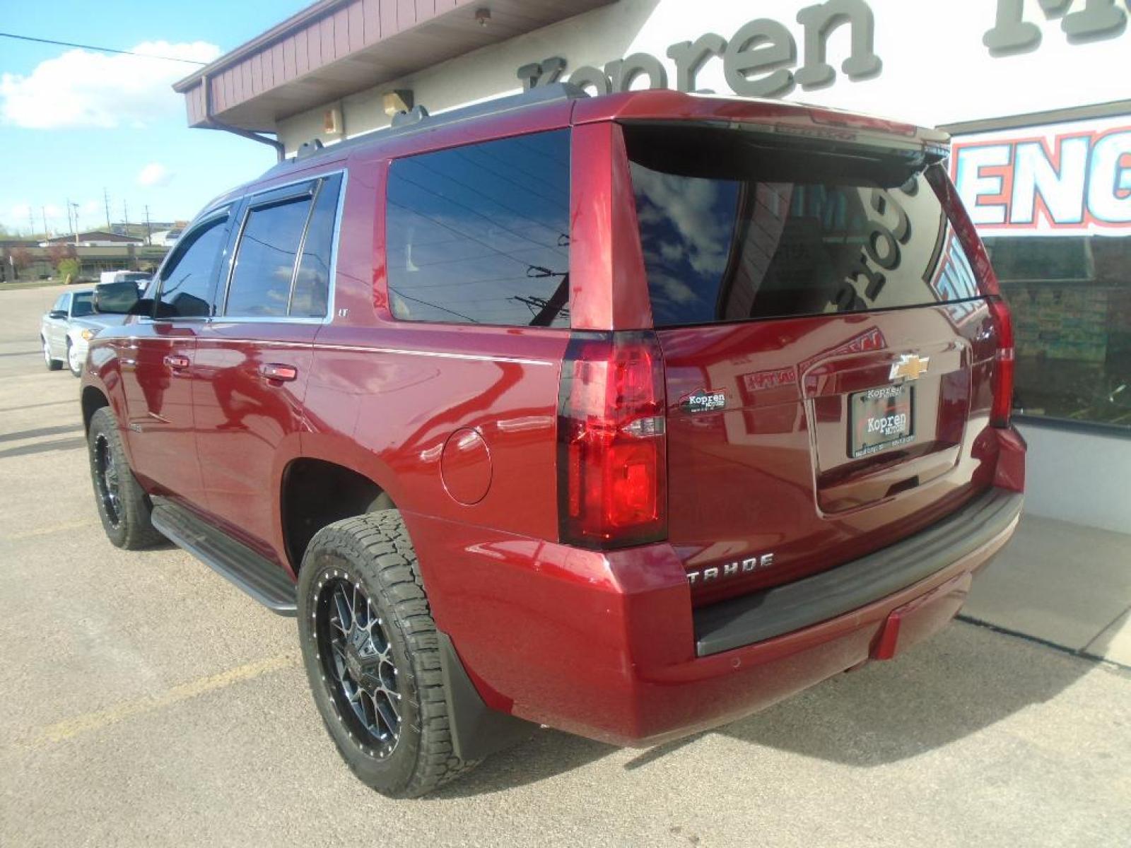 2018 Siren Red Tintcoat /Jet Black Chevrolet Tahoe LT (1GNSKBKC0JR) with an V8, 5.3L engine, 6-speed automatic transmission, located at 222 N Cambell St., Rapid City, SD, 57701, (866) 420-2727, 44.081833, -103.191032 - <b>Equipment</b><br>See what's behind you with the back up camera on this 2018 Chevrolet Tahoe . You'll never again be lost in a crowded city or a country region with the navigation system on this Chevrolet Tahoe. Engulf yourself with the crystal clear sound of a BOSE sound system in it. Bluetooth - Photo #1