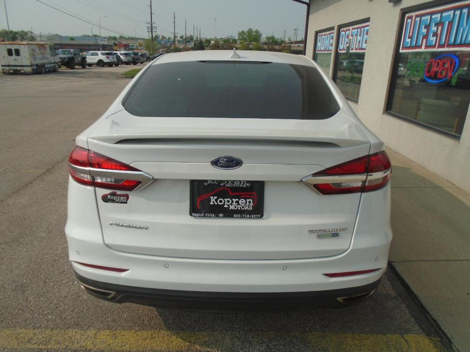 2019 Oxford White /Ebony Ford Fusion SEL (3FA6P0CD7KR) with an L4, 1.5L engine, 6-speed automatic transmission, located at 222 N Cambell St., Rapid City, SD, 57701, (866) 420-2727, 44.081833, -103.191032 - <b>Equipment</b><br>The rear parking assist technology on this model will put you at ease when reversing. The system alerts you as you get closer to an obstruction. This Ford Fusion features a hands-free Bluetooth phone system. See what's behind you with the back up camera on this unit. Set the tem - Photo #2
