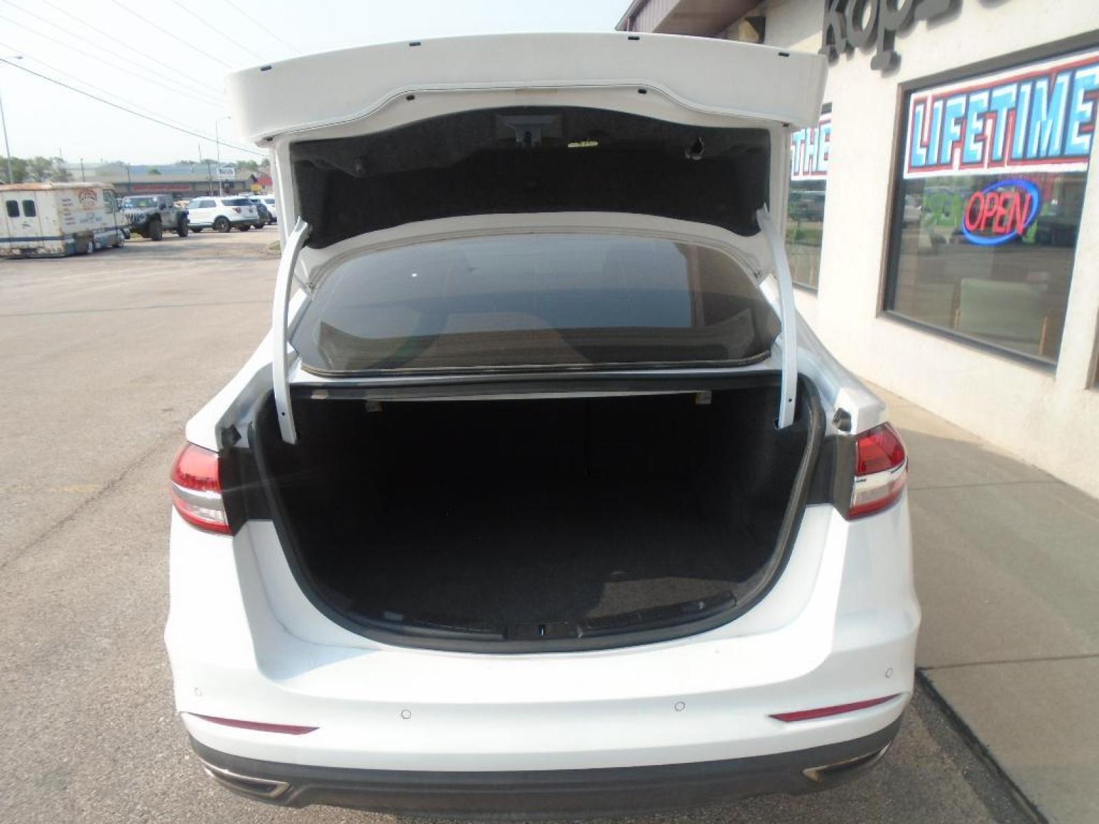 2019 Oxford White /Ebony Ford Fusion SEL (3FA6P0CD7KR) with an L4, 1.5L engine, 6-speed automatic transmission, located at 222 N Cambell St., Rapid City, SD, 57701, (866) 420-2727, 44.081833, -103.191032 - <b>Equipment</b><br>The rear parking assist technology on this model will put you at ease when reversing. The system alerts you as you get closer to an obstruction. This Ford Fusion features a hands-free Bluetooth phone system. See what's behind you with the back up camera on this unit. Set the tem - Photo #31