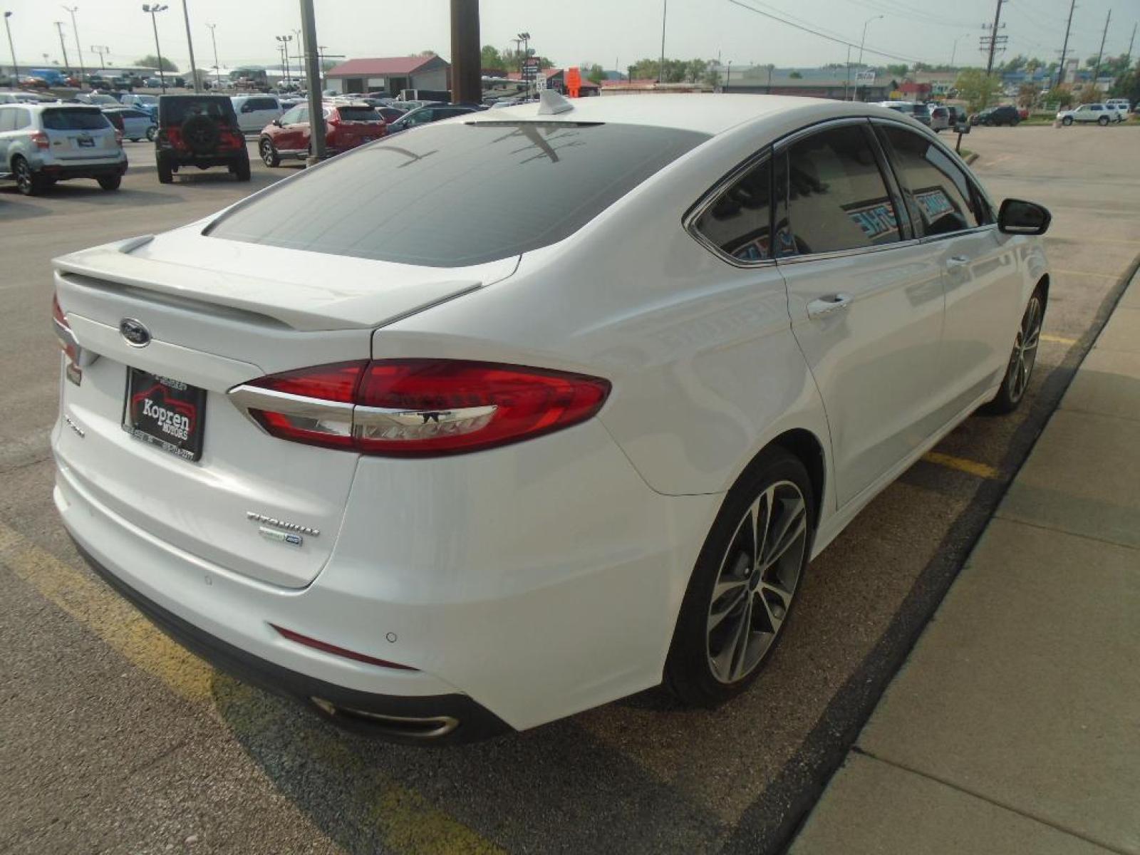2019 Oxford White /Ebony Ford Fusion SEL (3FA6P0CD7KR) with an L4, 1.5L engine, 6-speed automatic transmission, located at 222 N Cambell St., Rapid City, SD, 57701, (866) 420-2727, 44.081833, -103.191032 - <b>Equipment</b><br>The rear parking assist technology on this model will put you at ease when reversing. The system alerts you as you get closer to an obstruction. This Ford Fusion features a hands-free Bluetooth phone system. See what's behind you with the back up camera on this unit. Set the tem - Photo #3