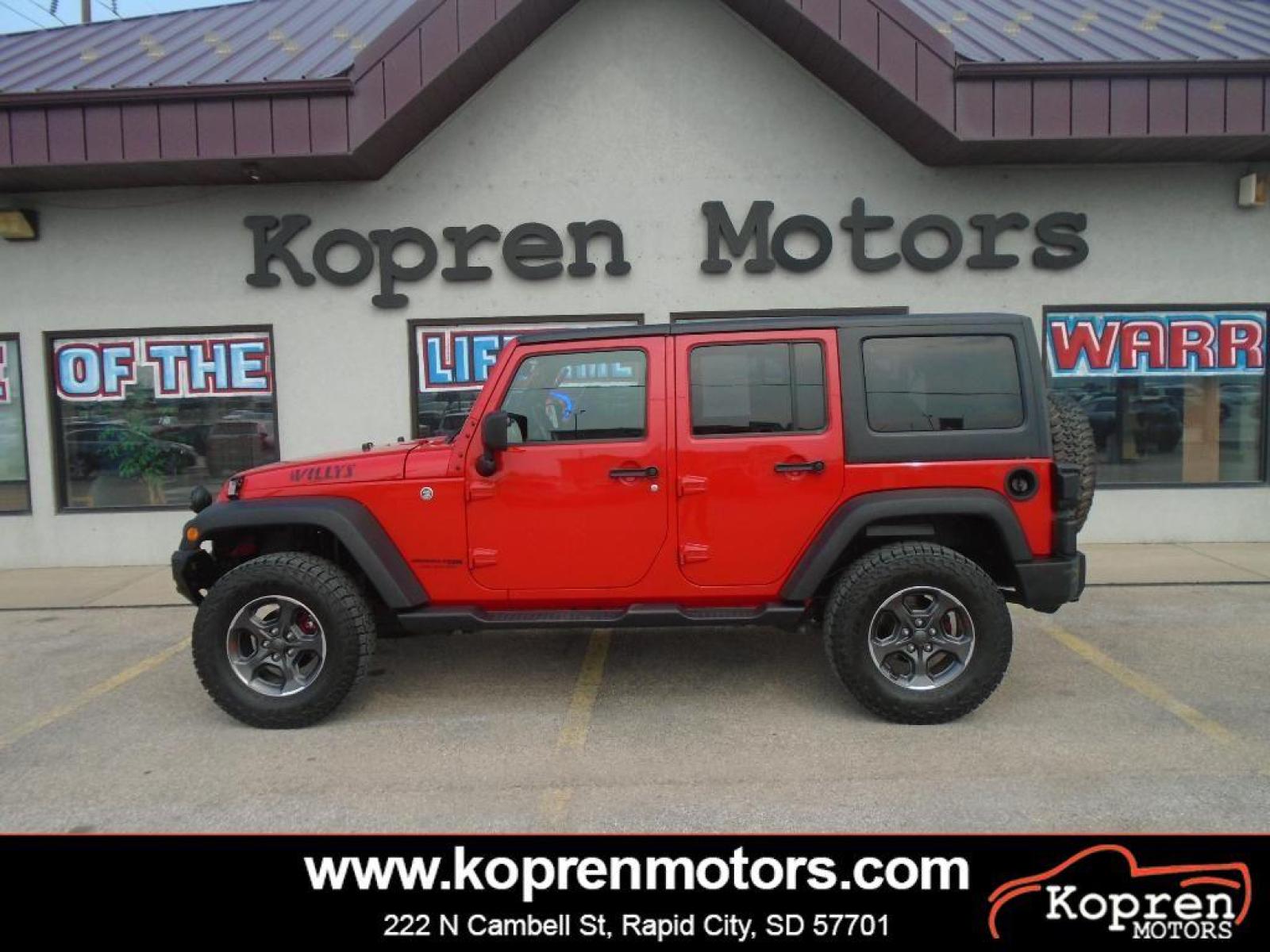 2018 RED /Black Jeep Wrangler Unlimited JK Willys Wheeler (1C4BJWDG0JL) with an V6, 3.6L engine, 5-speed automatic transmission, located at 222 N Cambell St., Rapid City, SD, 57701, (866) 420-2727, 44.081833, -103.191032 - <b>Equipment</b><br>Our dealership has already run the CARFAX report and it is clean. A clean CARFAX is a great asset for resale value in the future. It features a hands-free Bluetooth phone system. This vehicle has four wheel drive capabilities. This small suv is painted with a sleek and sophistic - Photo #0