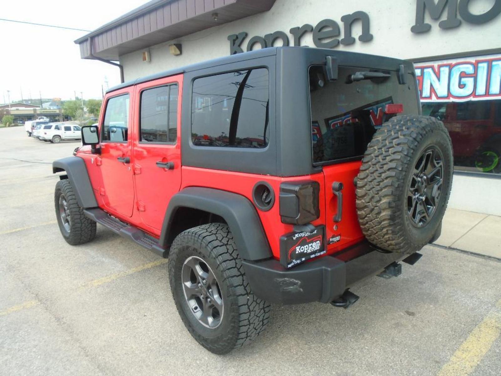 2018 RED /Black Jeep Wrangler Unlimited JK Willys Wheeler (1C4BJWDG0JL) with an V6, 3.6L engine, 5-speed automatic transmission, located at 222 N Cambell St., Rapid City, SD, 57701, (866) 420-2727, 44.081833, -103.191032 - <b>Equipment</b><br>Our dealership has already run the CARFAX report and it is clean. A clean CARFAX is a great asset for resale value in the future. It features a hands-free Bluetooth phone system. This vehicle has four wheel drive capabilities. This small suv is painted with a sleek and sophistic - Photo #1