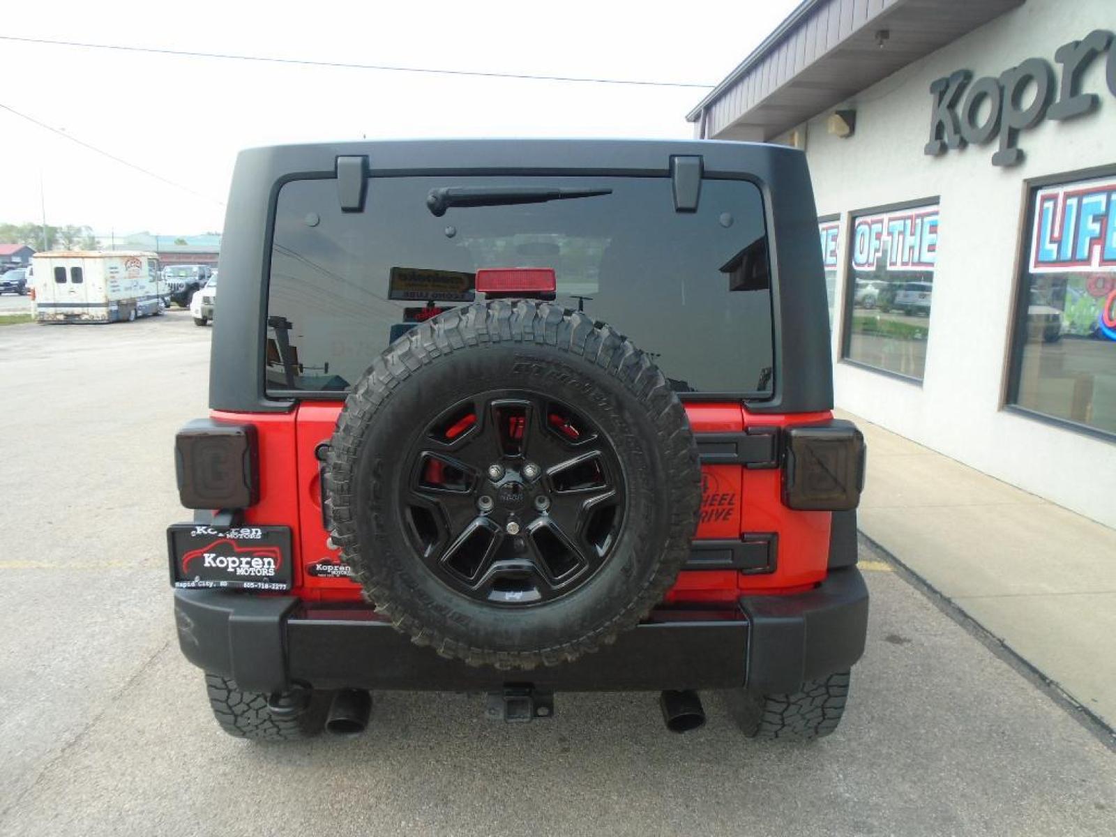 2018 RED /Black Jeep Wrangler Unlimited JK Willys Wheeler (1C4BJWDG0JL) with an V6, 3.6L engine, 5-speed automatic transmission, located at 222 N Cambell St., Rapid City, SD, 57701, (866) 420-2727, 44.081833, -103.191032 - <b>Equipment</b><br>Our dealership has already run the CARFAX report and it is clean. A clean CARFAX is a great asset for resale value in the future. It features a hands-free Bluetooth phone system. This vehicle has four wheel drive capabilities. This small suv is painted with a sleek and sophistic - Photo #2
