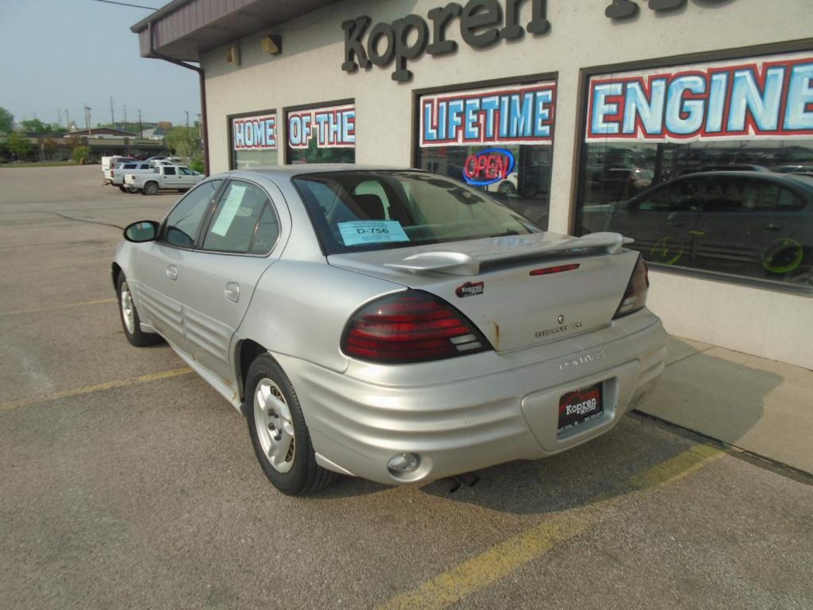 2002 Galaxy Silver Metallic Pontiac Grand Am SE1 (1G2NF52F22C) with an L4, 2.2L engine, 5-speed manual transmission, located at 222 N Cambell St., Rapid City, SD, 57701, (866) 420-2727, 44.081833, -103.191032 - The Pontiac Grand Am shines with an exquisite metallic silver exterior finish. The vehicle has a L4, 2.2L high output engine. This model is front wheel drive. Maintaining a stable interior temperature in this 2002 Pontiac Grand Am is easy with the climate control system. Anti-lock brakes are standa - Photo #1